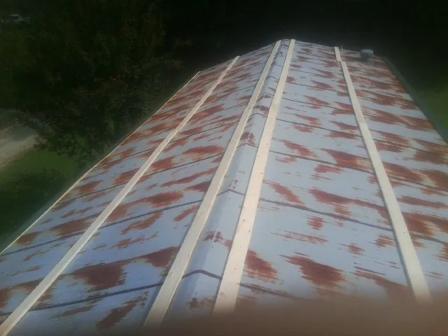 Rusted metal roof panels with new wood purlins before replacement — Storm Damage Roof Repair in Talking Rock by Roofing Brothers