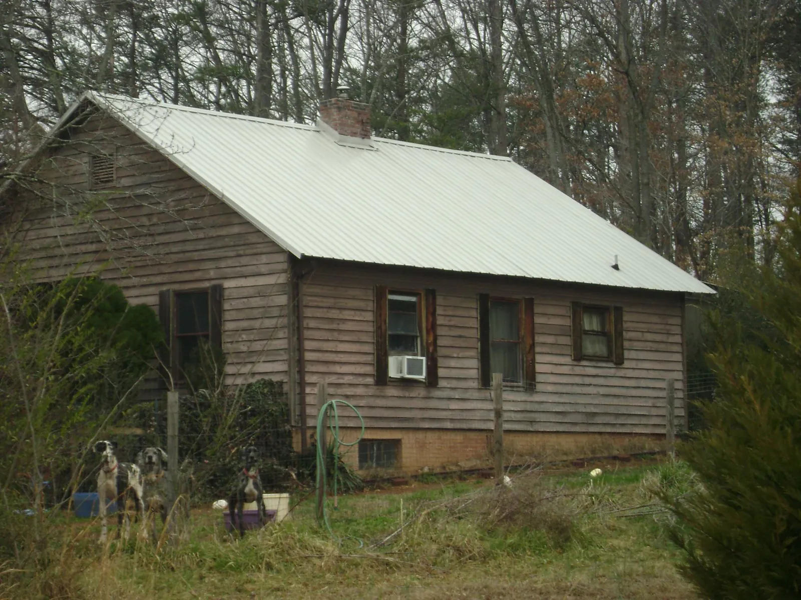 White metal roof on an old wood sided farmhouse, from a Metal Roof Installation job in Talking Rock